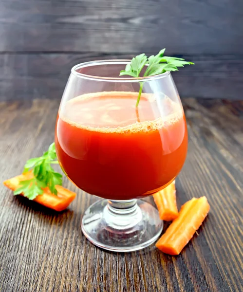 Juice carrot with parsley in wineglass on board — Stock Photo, Image