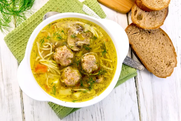 Soup with meatballs and noodles in bowl on napkin top — Stock Photo, Image