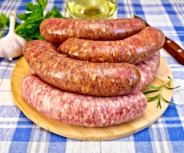 Sausages pork and beef on blue cloth — Stock Photo, Image