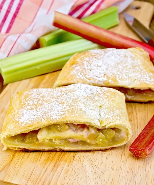 Strudel with rhubarb and napkin on board — Stock Photo, Image