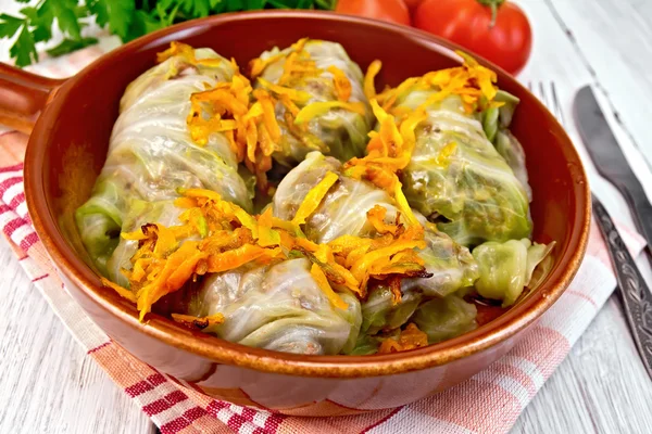 Cabbage stuffed with sauerkraut in ceramic pan on board — Stock Photo, Image