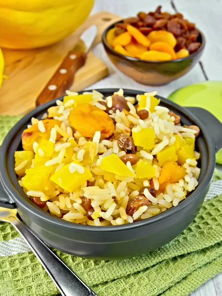 Pilaf fruit with pumpkin in pan on board — Stock Photo, Image