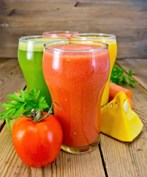 Juice tomato and vegetables in glasses on board — Stock Photo, Image