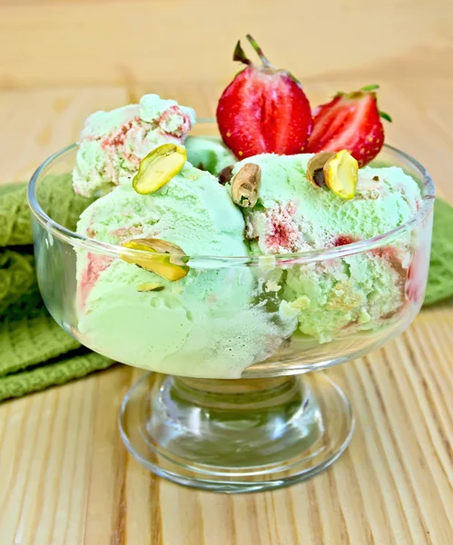 Ice cream strawberry-pistachio with napkin on board — Stock Photo, Image