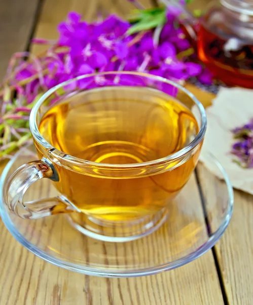 Tea from fireweed in glass cup on board — Stock Photo, Image