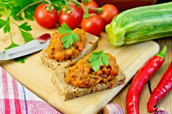 Sandwich with caviar squash and peppers on board — Stock Photo, Image