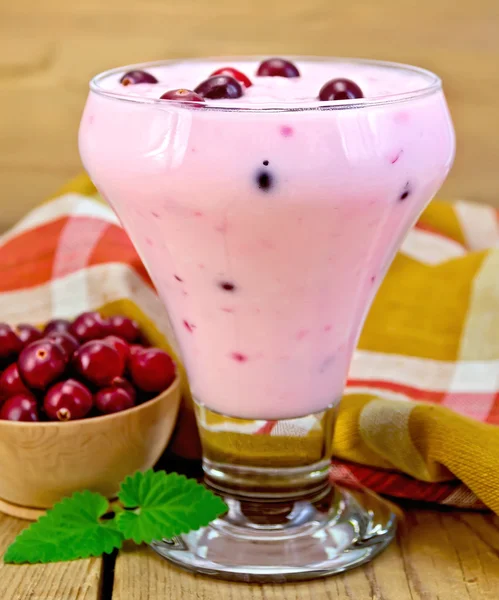 Yogurt thick with cranberries and napkin on board — Stock Photo, Image