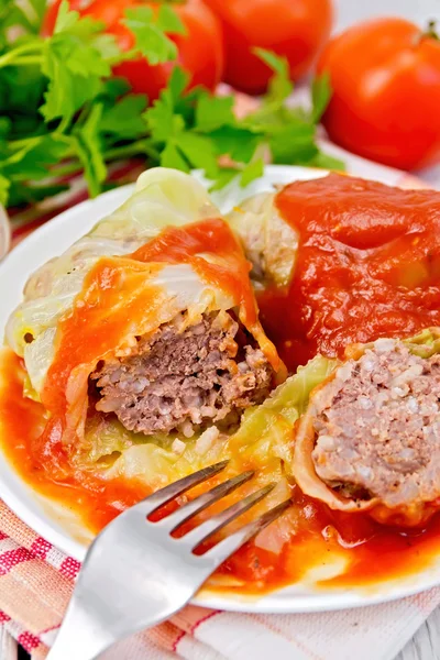 Cabbage stuffed with fork in plate on board — Stock Photo, Image