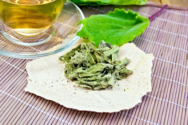 Sage dried on paper with cup on board — Stock Photo, Image