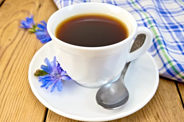 Chicory drink in white cup with flower and napkin on board — Stock Photo, Image