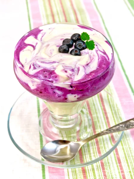 Dessert milk with blueberries on striped tablecloth — Stock Photo, Image