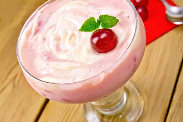 Dessert milk with cherry and red napkin — Stock Photo, Image