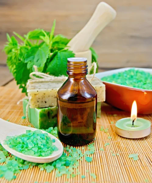 Oil and salt with nettles in mortar on board — Stock Photo, Image