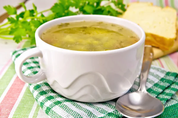 Soup of green peas with bread on tablecloth — Stock Photo, Image