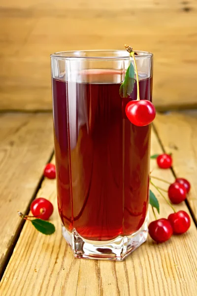 Compote cherry in tall glass on board Royalty Free Stock Photos