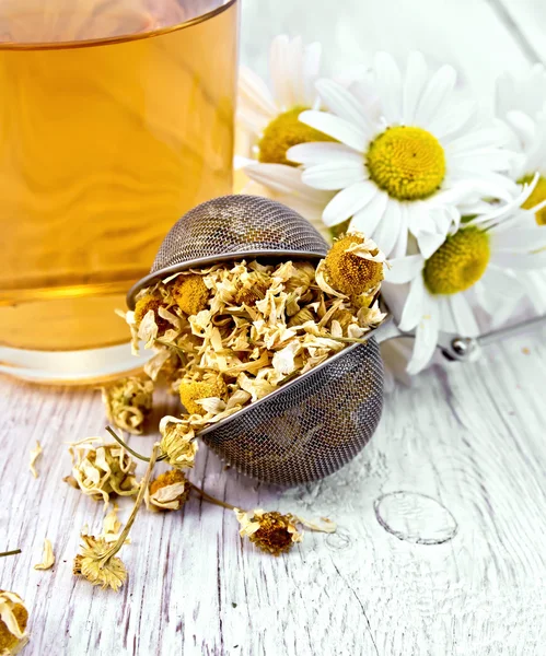 Chamomile dried in strainer on board — Stock Photo, Image