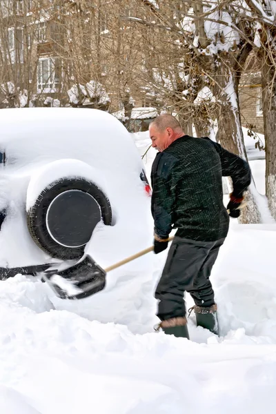 Man with a shovel in snow — Stock Photo, Image