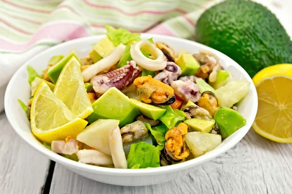 Salad seafood and lemon on white board — Stock Photo, Image