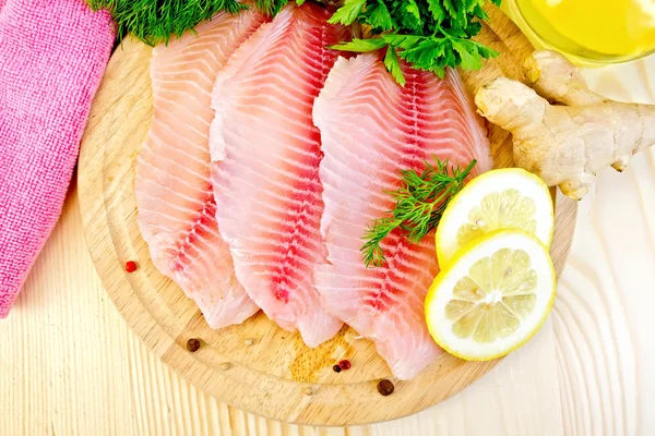 Tilapia with ginger and lemon on board — Stock Photo, Image
