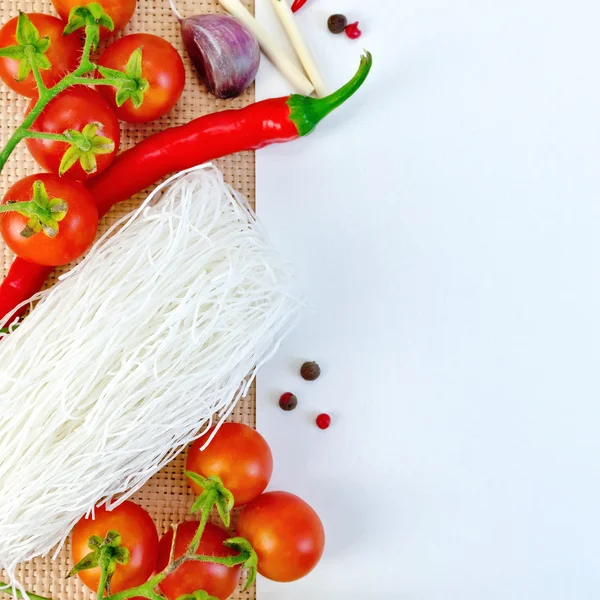 Frame of funchoza and tomatoes with paper on sacking — Stock Photo, Image