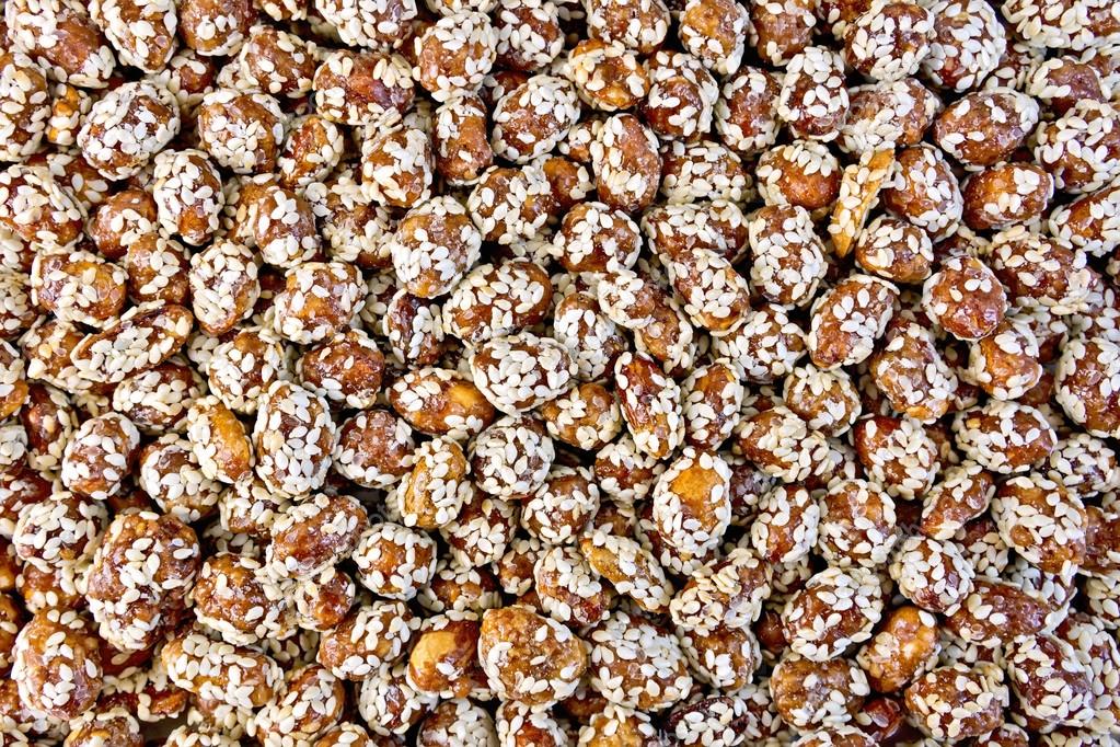 Peanuts in caramel with sesame texture — Stock Photo © rezkrr 69473339