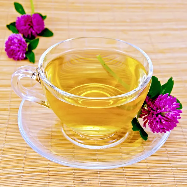 Herbal tea with clover on bamboo napkin — Stock Photo, Image