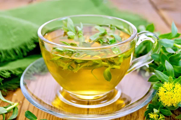 Herbal tea with Rhodiola rosea and napkin on board — Stock Photo, Image