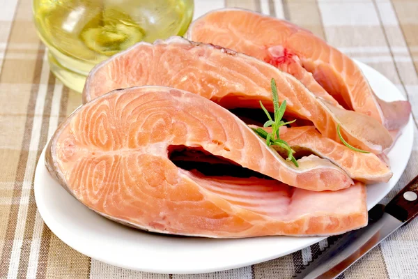 Trout in plate with rosemary and oil on napkin — Stock Photo, Image
