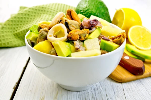 Salad seafood and avocado in bowl on light board — Stock Photo, Image