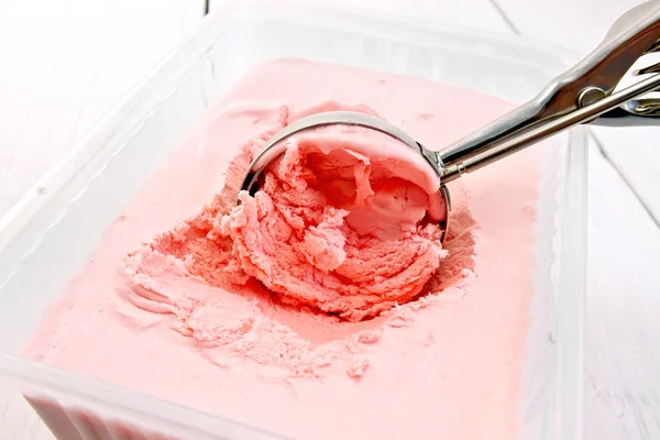 Ice cream strawberry in scoop and tray on board — Stock Photo, Image