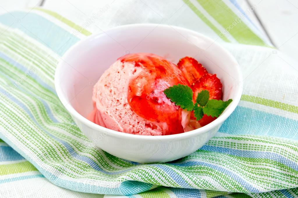 Ice cream strawberry with syrup in bowl on napkin
