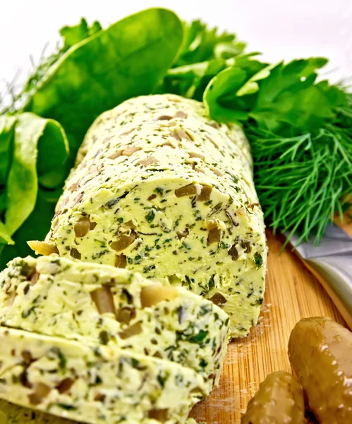 Butter with spinach and cucumbers on board — Stock Photo, Image