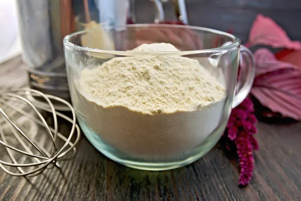 Flour amaranth in glass cup with mixer on board — Stock Photo, Image