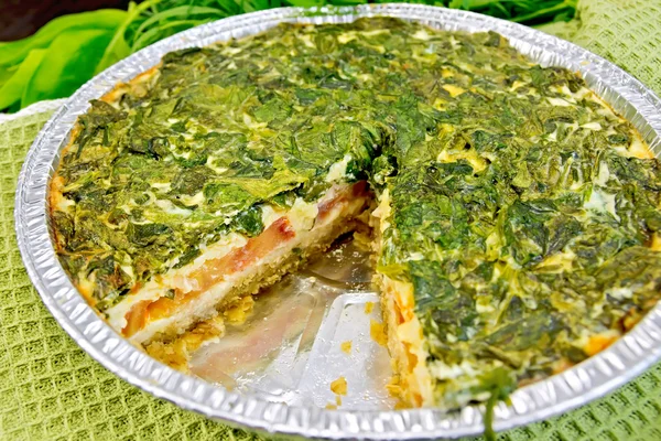 Céltico de torta com espinafre e tomate em forma de papel alumínio a bordo — Fotografia de Stock