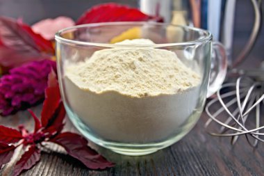 Flour amaranth in glass cup on board