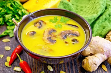 Soup-puree pumpkin with mushrooms and ginger on board