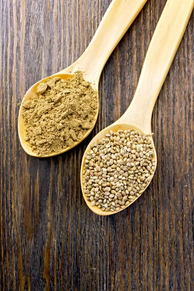 Flour and seed of hemp in wooden spoon on board — Stock Fotó