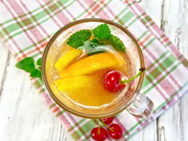 Lemonade with cherry in wineglass on board top — 图库照片