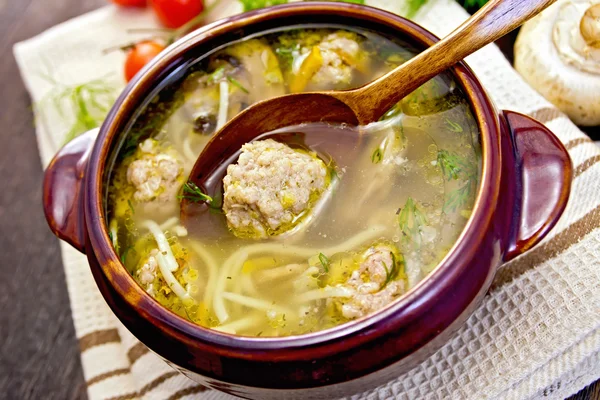 Soup with meatballs and noodles in pottery on napkin — Stock Fotó