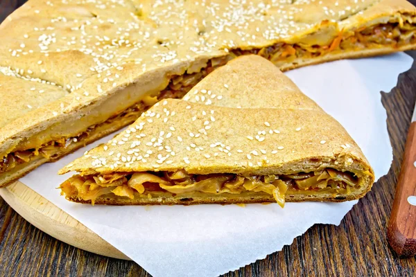 Pie with cabbage and sesame on paper — Φωτογραφία Αρχείου