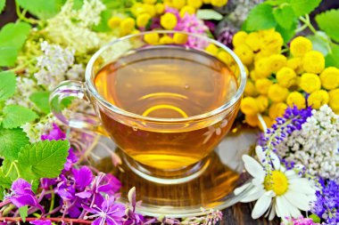 Tea from flowers in glass cup on dark board