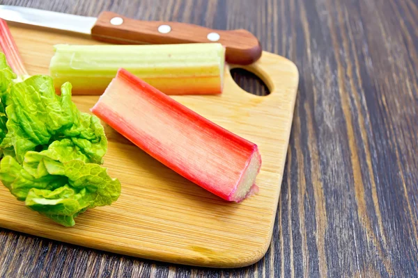 Rhubarb with knife on board — Stok fotoğraf