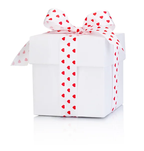 White gift box tied satin ribbon bow with heart symbol Isolated — Stock Photo, Image