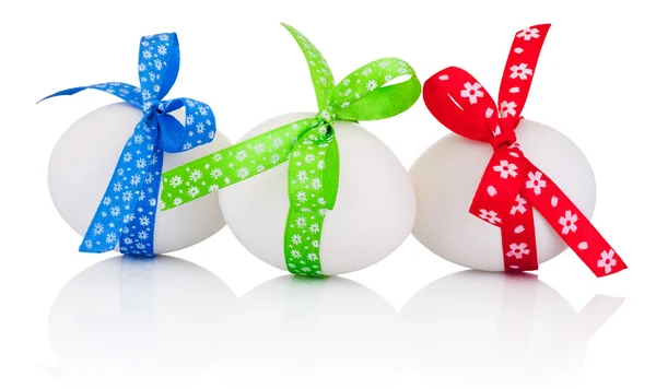 Three Easter eggs with festive bow isolated on white background — Stock Photo, Image