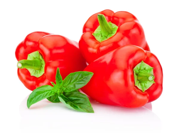 Three bell Red Peppers with green leaves basil isolated on white b — Stock Photo, Image