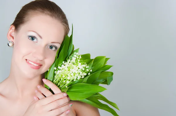 Girl with a bouquet of lilies of the valley — Stock Photo, Image