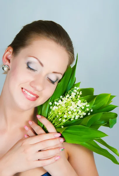 Girl with a bouquet of lilies of the valley — Stock Photo, Image
