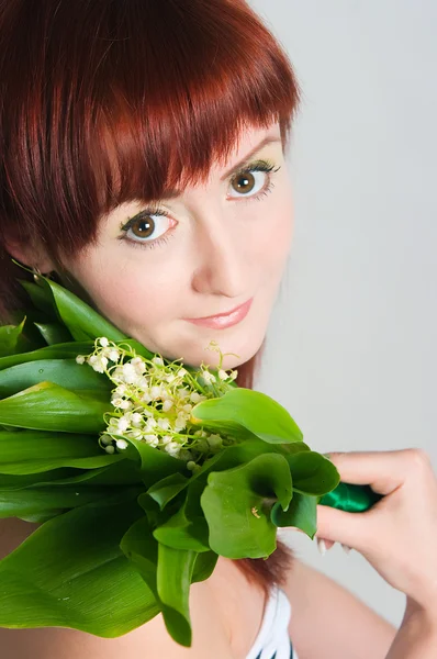 The girl with a bouquet of lilies of the valley — Stock Photo, Image