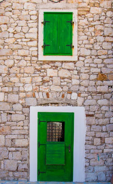 Green door and window shutters in Croatia — Stock Photo, Image