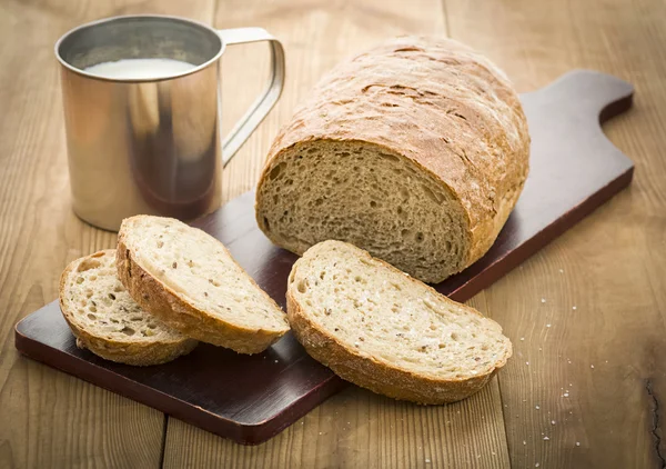 Bochenek chleba na pokładzie i mleka — Zdjęcie stockowe